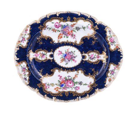 A WORCESTER BLUE-SCALE GROUND OVAL DISH OR STANDCIRCA 1770Painted with panels of flowers within gilt C-scroll borders, blue f