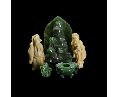 A GROUP OF FOUR JADE AND SOAPSTONE CARVINGS20TH CENTURYIncluding: A spinach jade of Guanyin, 15.5cm high; a spinach jade of c