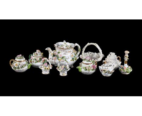 A SELECTION OF ROCKINGHAM FLOWER ENCRUSTED PORCELAIN CIRCA 1830Including miniature teapots, baskets, a scent bottle and stopp