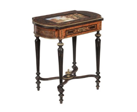 AN EBONISED AND GILT METAL OCCASIONAL TABLE IN NAPOLEON III STYLECIRCA 1870 With hinged ceramic inset top above the single dr