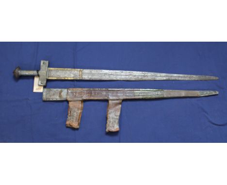 An ethnic sword with tooled leather scabbard and metal embellishment