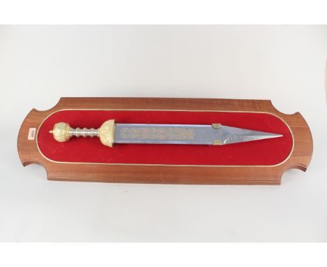 A Franklin Mint 'model' of the sword of Julius Caesar, mounted on a wooden framed shield with original leaflet