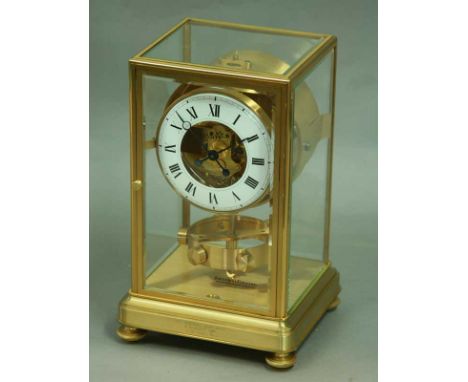 A JAEGER LE COULTRE MANTEL CLOCK with white enamel chapter ring in brass glazed case. Presentation 1981 height 10.5" (26.5cm)