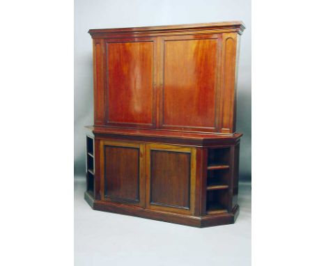 A VICTORIAN MAHOGANY BOOKCASE the upper part enclosed by panel doors, the base with open shelves on the angles width 78" (198