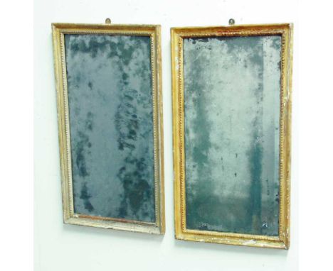 A PAIR OF GEORGE III WALL MIRRORS each with rectangular bevelled plates in gilt frames 14.5" (37cm) x 26.5" (67cm)