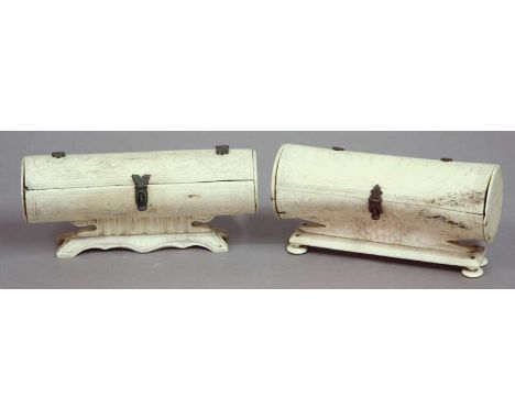 TWO BONE CASKETS cylindrical with hinged covers and engraved with leafy scrolls, one with a coat of arms.  Possibly Sri Lanka