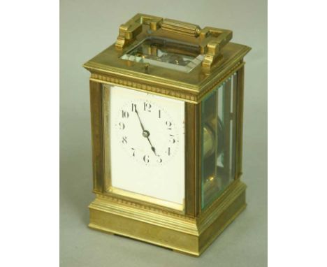 A CARRIAGE CLOCK with platform escapement and enamel dial, the movement chiming and repeating the quarters on four coils, in 