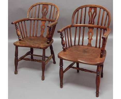 TWO SIMILAR ELM AND ASH WINDSOR ARM CHAIRS with stick backs on turned legs