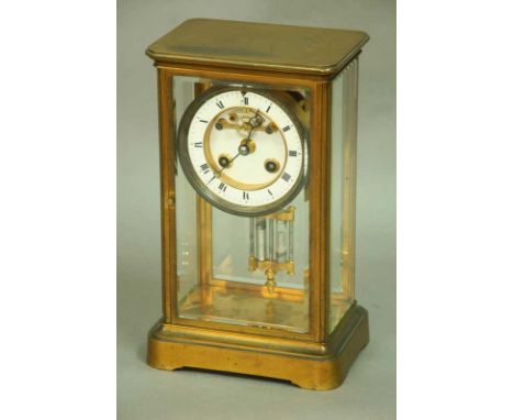 A FRENCH MANTEL CLOCK with brocot type escapement and striking on a bell.  Enamel dial and chapter ring in a brass glazed cas