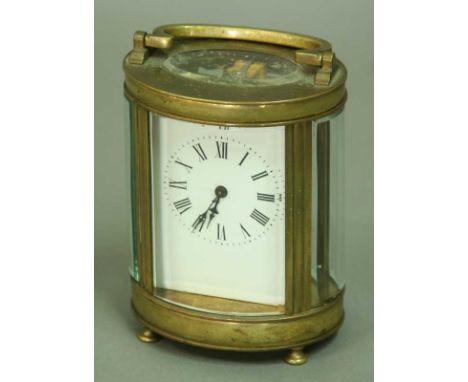 A CARRIAGE TIMEPIECE with platform escapement and enamel dial in oval brass and glazed case 6" (15cm)