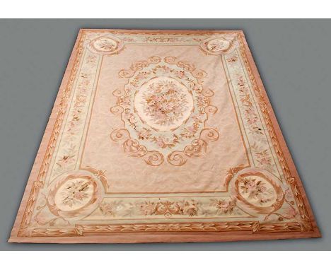 A MODERN CARPET IN AUBUSSON STYLE with a floral design in tones of beige, pink and green approx 140" x 108" (356cm x 274cm)