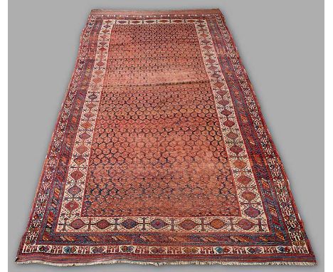 A LURI KELLEH CARPET with all over boteh field and ivory sherkalu style border with striped kelim ends.  (Overall wear, heavy