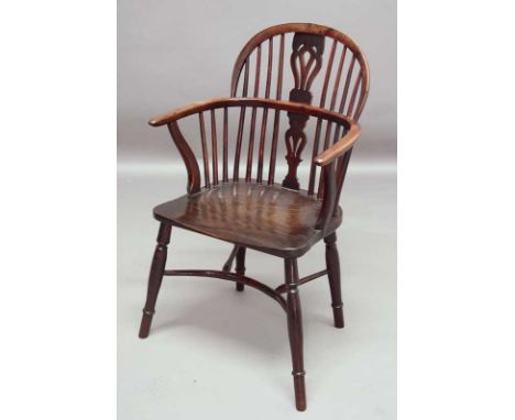 A WINDSOR ARM CHAIR OF YEW AND ELM with stick back, pierced splat and curved stretcher