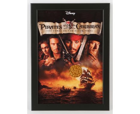 Pirates of the Caribbean: The Curse of the Black Pearl (2003) - A prop pirate coin in a framed display, 9.5 x 13 inches overa