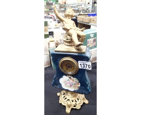 French ceramic clock with brass cherub surmount 