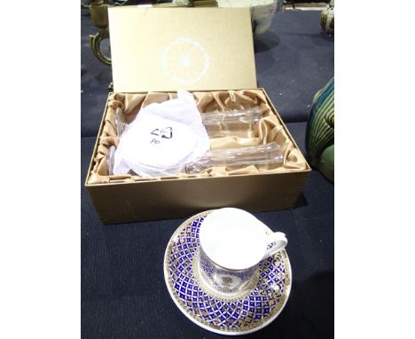 Boxed 2002 Golden Jubilee champagne glasses and a cup and saucer 