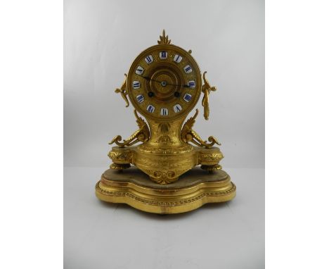 A 19th century French gilt spelter mantle clock, having eight day half cylinder movement, having ceramic Roman numeral plaque