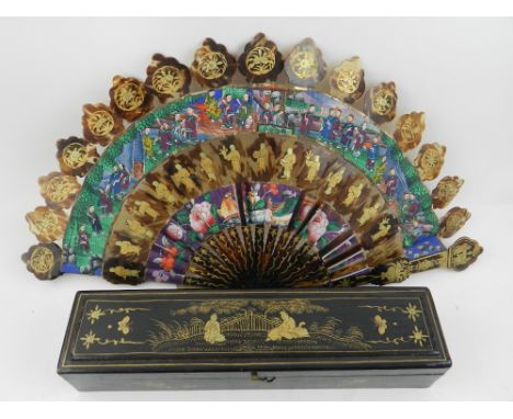 A 20th century Chinese fan, having faux tortoiseshell segmented guards and stick.