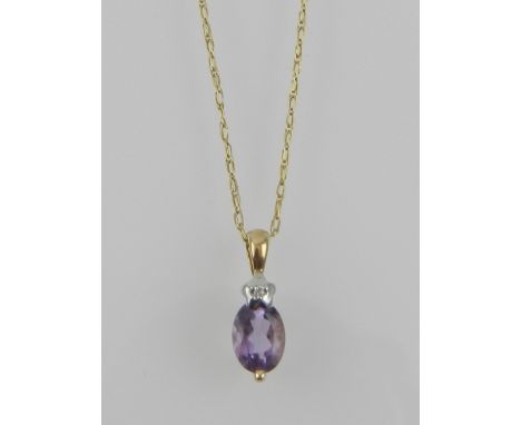 A yellow metal, diamond and amethyst set pendant, the suspension loop stamped 375, suspended on a fine yellow metal chain. 