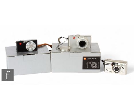 Three Leica digital cameras to include, a boxed Leica D-LUX 2 ultra compact digital camera with silver body, with battery cha