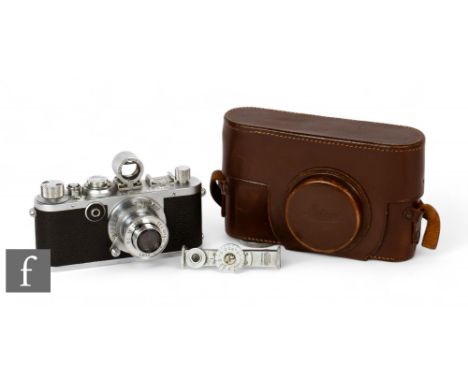 A Leica If camera, circa 1951, with f=5cm 1:3,5 lens, chrome body, serial number 563062, with rangefinder and leather case.