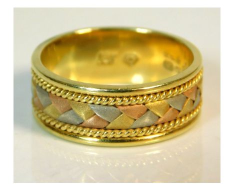 A three colour 18ct gold band, signed RP, 5.5g, size K/L