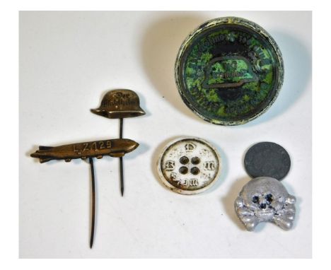 A German Der Stahlhelm pin badge, an L. Z. 129 Hindenburg badge, a German coin, a Third Reich BDM button, a German skull &amp