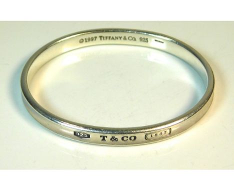 A 1997 Tiffany &amp; Co. silver bangle with original box, 62mm internal diameter, 31.5g, inscribed "Love Terry"