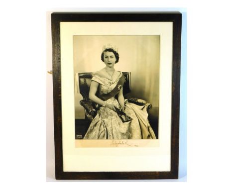 A framed Dorothy Wilding studio portrait photograph of Queen Elizabeth II in 1952, hand signed &amp; dated by the Queen herse