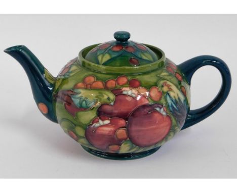 A Moorcroft pottery teapot with fruit decor, green signature to base, 9.25in wide x 4.25in high
