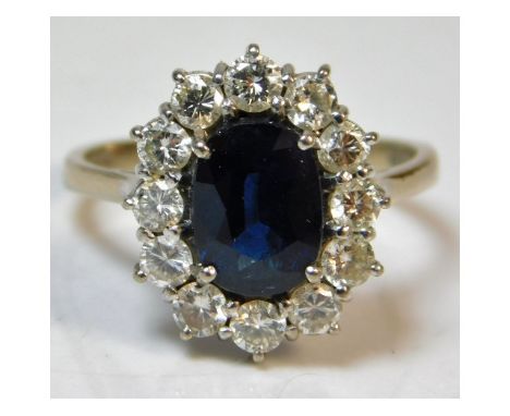 An 18ct white gold diamond &amp; sapphire ring, approx. 0.84ct diamond, sapphire 9.2mm at widest point, 5.7g, size P