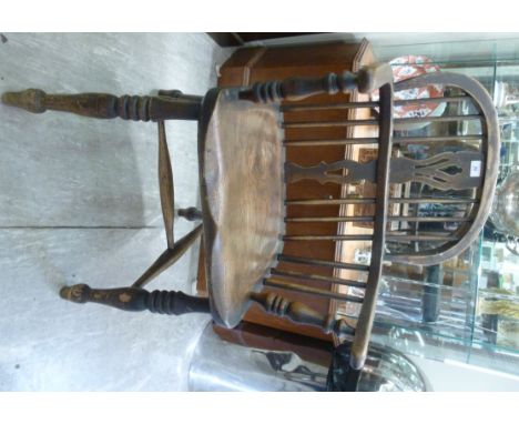 A mid 19thC oak and elm framed Windsor chair, having a low hoop and stick back, a pierced splat and level arms, on baluster a