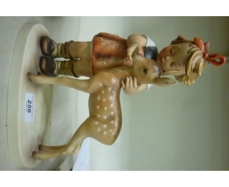 A Goebel porcelain model, a young girl standing beside a fawn  11''h       OS8