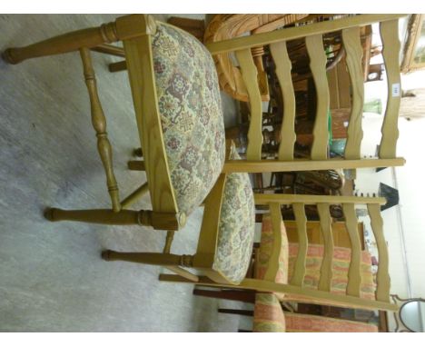 A pair of Parker Knoll light oak framed ladderback dining chairs, the tapestry upholstered, drop-in seats raised on turned fo