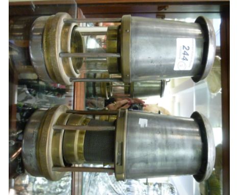 Two steel and brass miners lamps: to include a Safety Lamp Company 'The Wolf'  8.5''h       RSF
