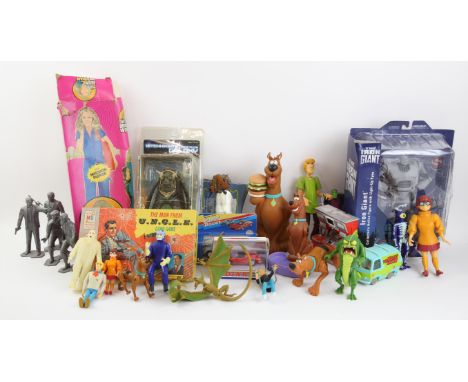Large collection of action figures and toys including Hitchhiker's Guide to the Galaxy, The Iron Giant, The Bionic Woman, Din