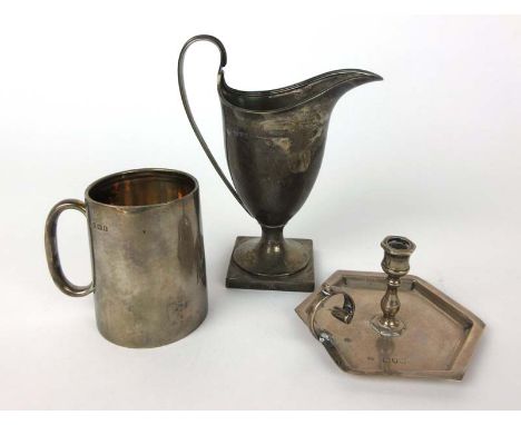 An Edwardian silver helmet shaped cream jug together with a silver christening tankard and a chamber stick of small proportio