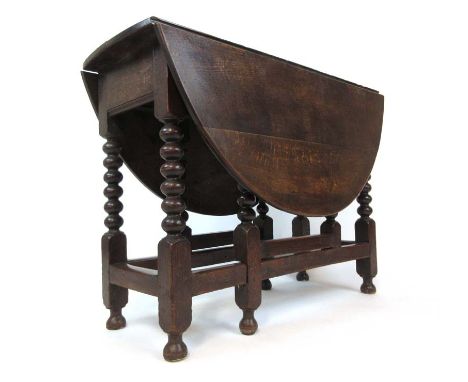 An 18th century and later oak drop leaf table, the leaves supported on single gate action with bobbin turned legs, h. 76 cm, 