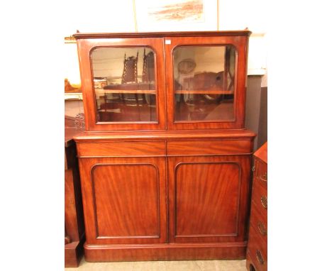 A Victorian mahogany bookcase, the galleried top over two glazed doors enclosing adjustable shelf, two drawers and two blind 