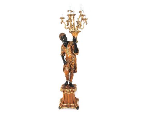 A reproduction carved wood and parcel gilt blackamoor figure holding a nine branch lamp, h. 195 cm CONDITION REPORT: General 