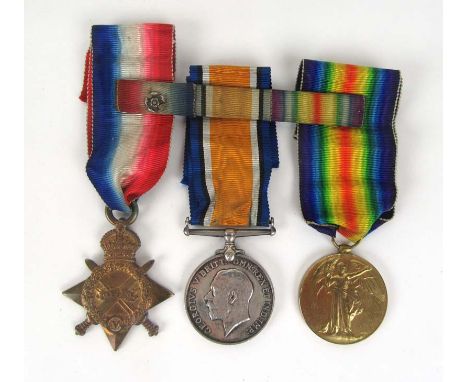 A WWI medal trio consisting of the 1914-15 star, British war medal, victory medal and ribbon bar with rosette. Issued to Priv