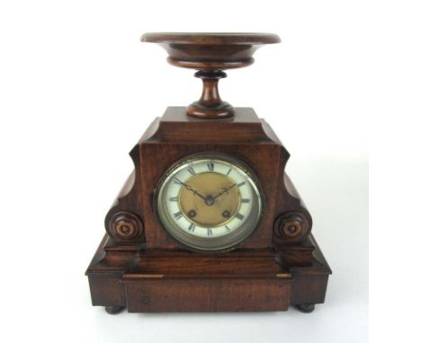 A 19th century French walnut mantle clock having display bowl to top, the face with Roman numerals and pierced hands behind b