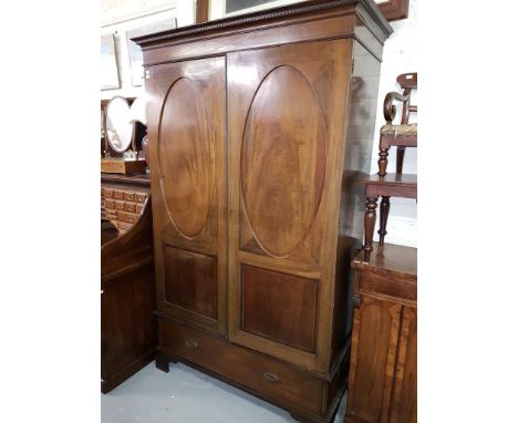 AN ATTRACTIVE INLAID MAHOGANY WARDROBE, the dentil-moulded cornice above two doors, each with an oval inlaid and cross banded