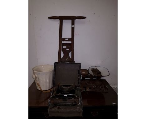 AN OLD WOODEN FOOT JACK, with two turned handles; an English cream-coloured toilet bowl with liner; an old cast iron and enam