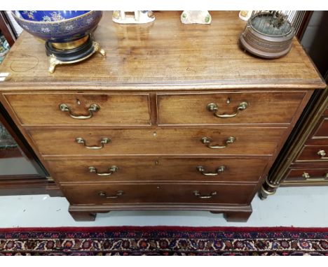 A GOOD GEORGIAN AND CROSS-BANDED MAHOGANY CHEST, with three long and two short drawers, under a moulded top and raised on bra