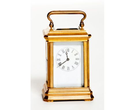 A MINIATURE FRENCH CARRIAGE CLOCK, with five glass panels and and a swing handle, raised on a rectangular moulded base, 3" (8