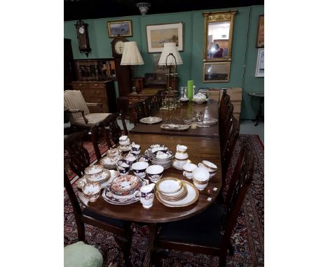 A REGENCY STYLE TRIPLE PEDESTAL MAHOGANY DINING TABLE, with three spare leaves, the moulded top with demi-lune ends, raised o