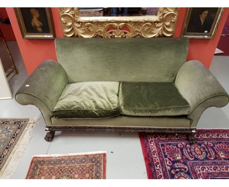 A VERY UNUSUAL CHIPPENDALE STYLE MAHOGANY SETTEE, with scroll arms and padded back over a cushion seat, the frieze carved wit