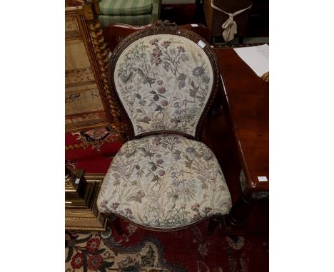 AN ATTRACTIVE LATE NINETEENTH CENTURY WALNUT FAUTIL OR OPEN ARMCHAIR, the ribbon moulded frame with floral crest, above an ar