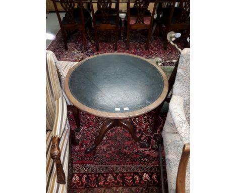 A GEORGIAN PERIOD CIRCULAR MAHOGNAY FLIP-TOP CENTRE TABLE, now with tooled leather surface on an upward tapering turned stem 